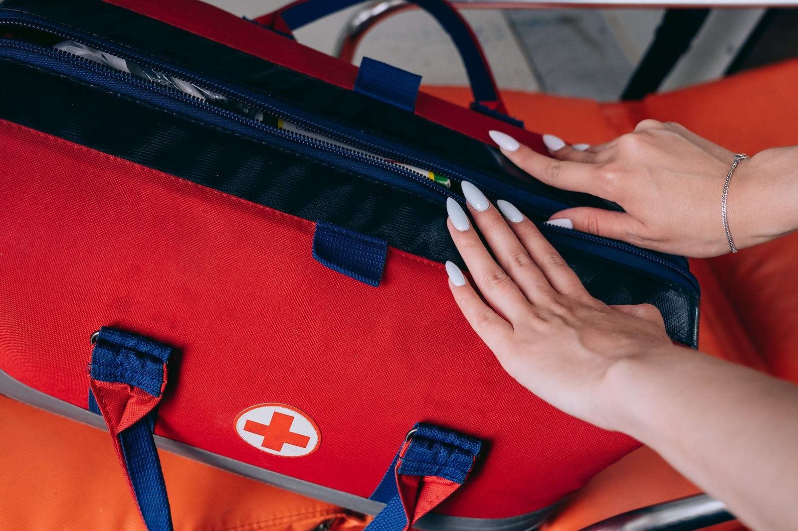 close up of paramedic unzipping an emergency aid kit