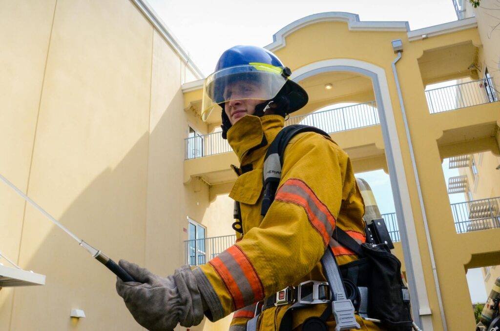 photo of firefighter beside building