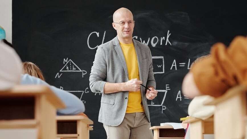 teacher standing in front of a blackboard