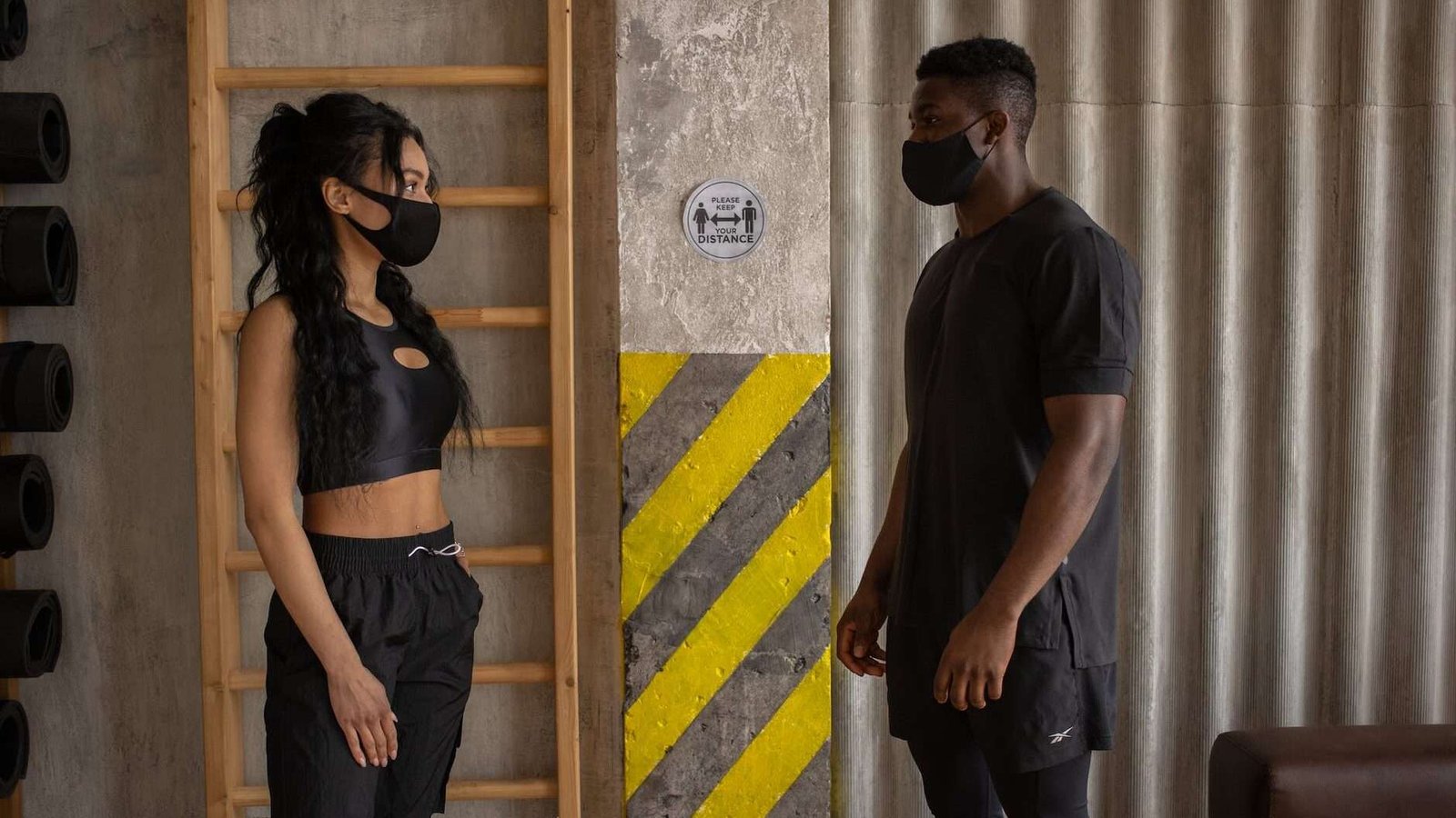 female and african american male in medical masks