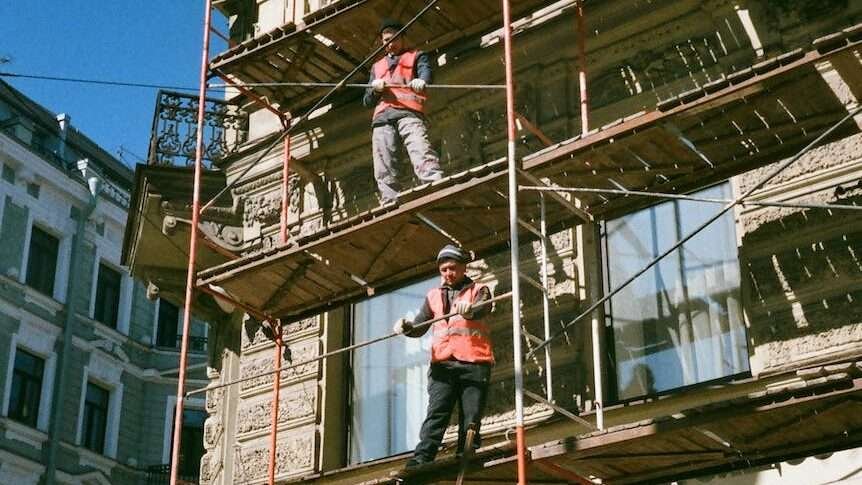 men on brown scaffolding