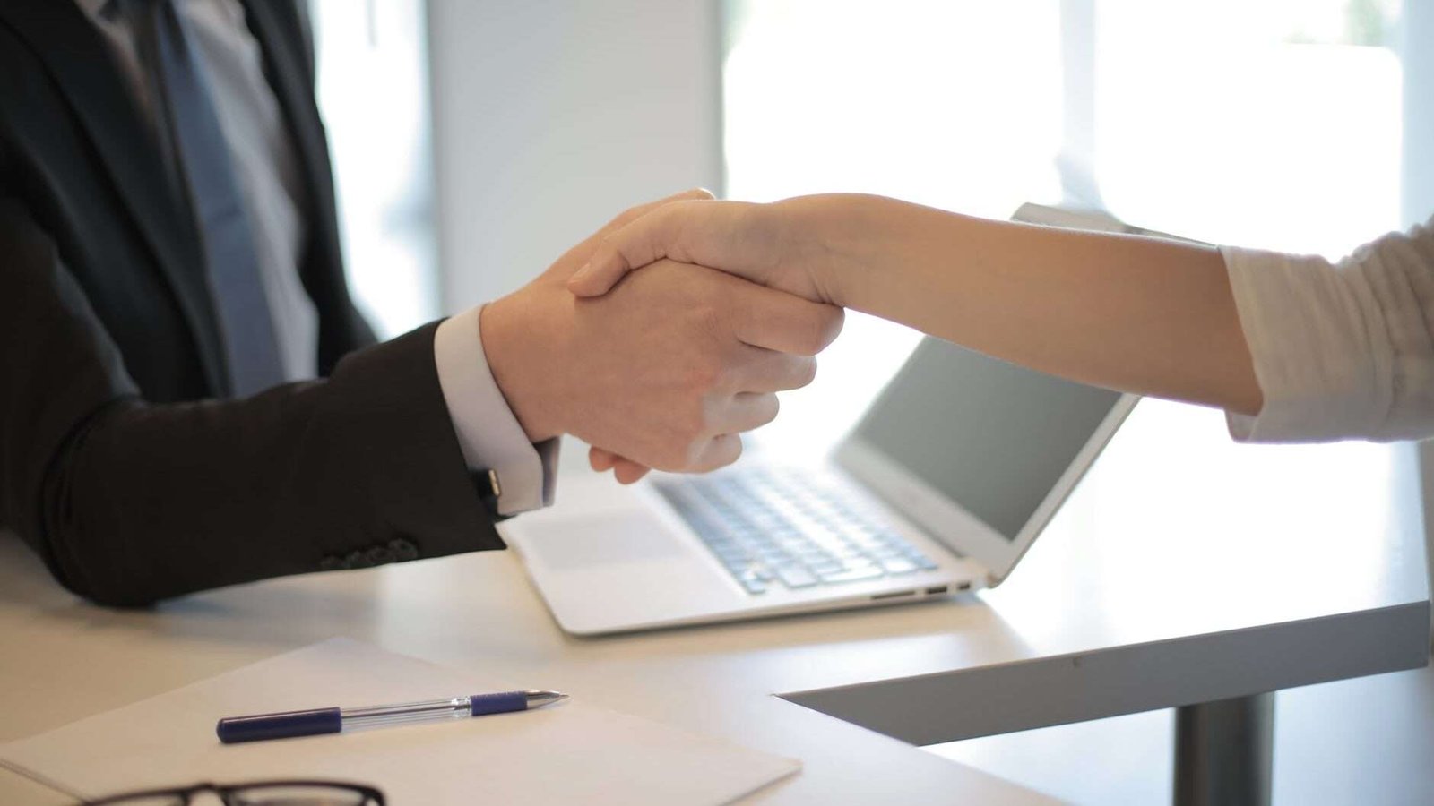 person in black suit hired an employee