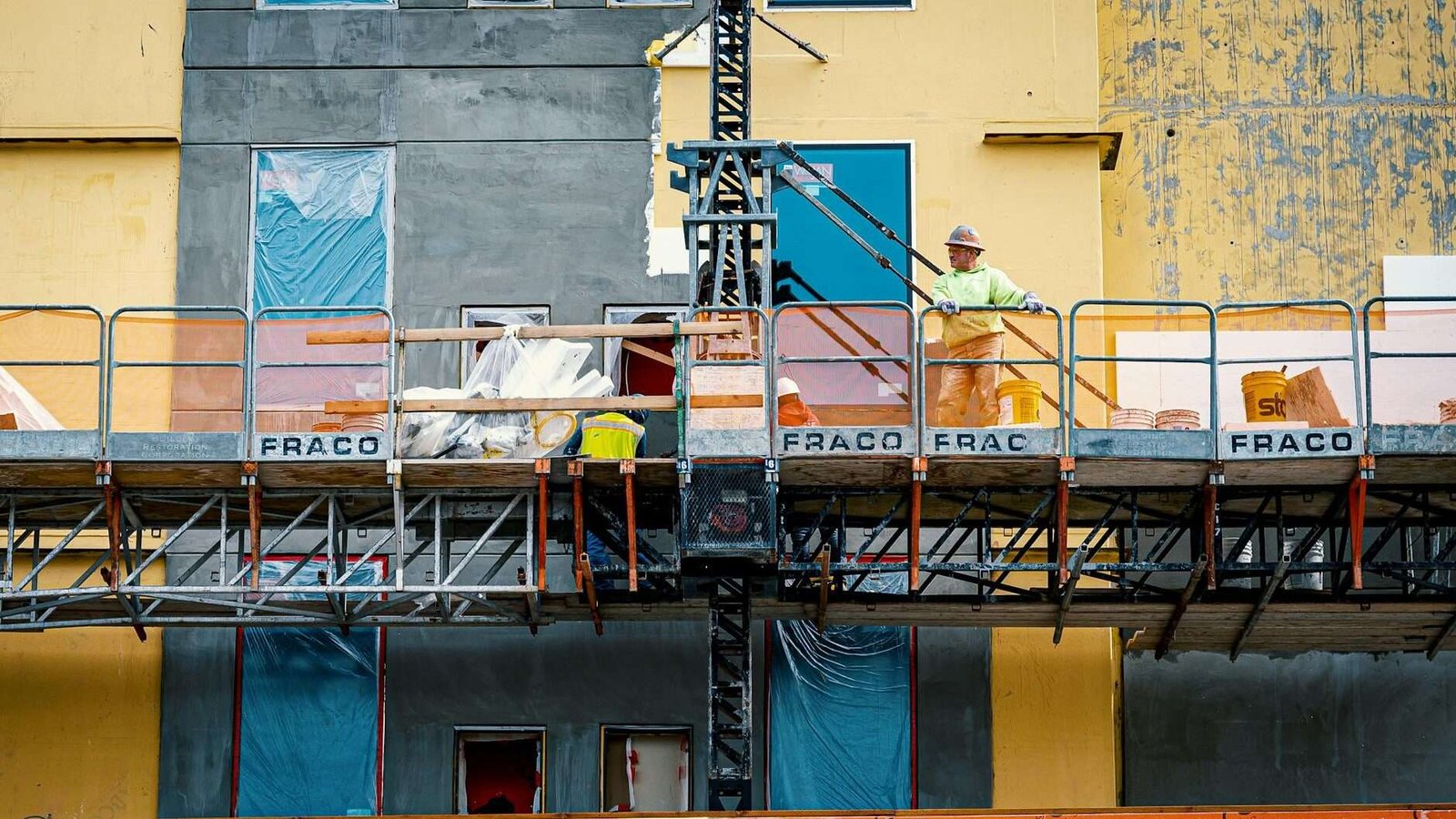 builder on lifting platform during site works