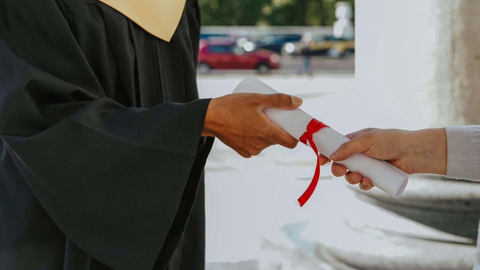 closeup of a graduate student receiving a diploma