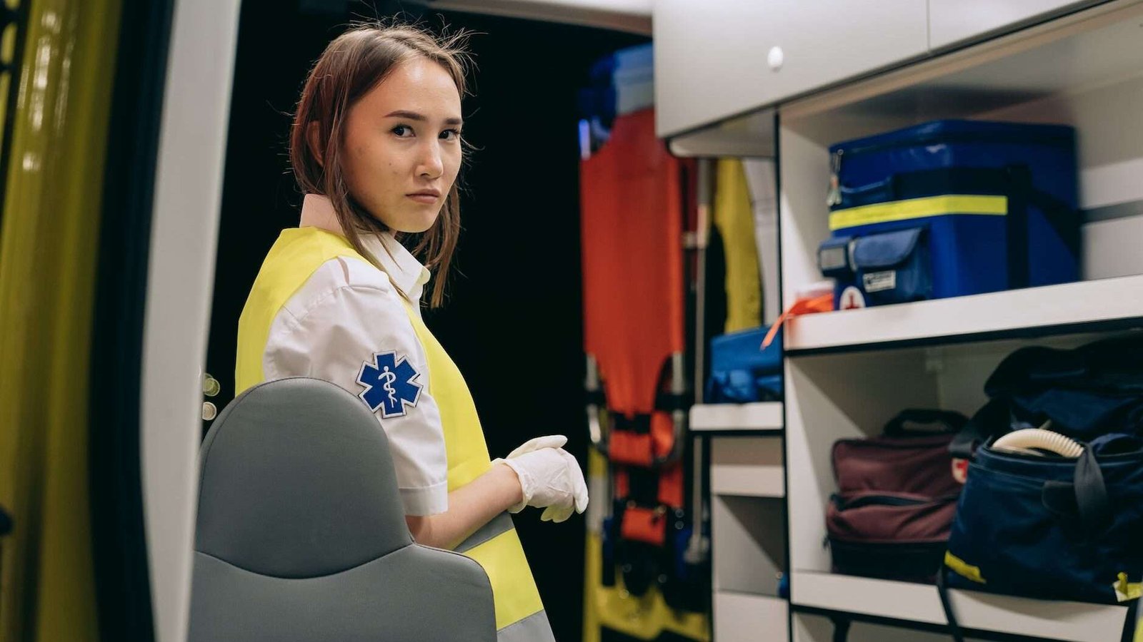 paramedic standing at the of an ambulance