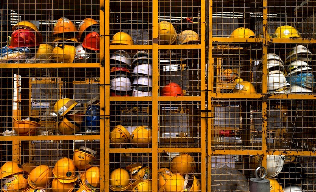 a rack filled with lots of yellow hard hats